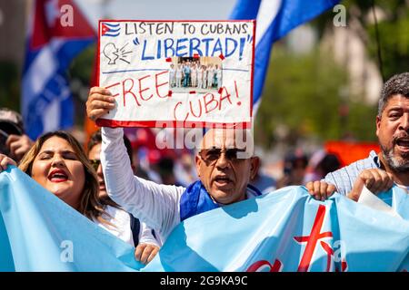 Washington, DC, USA, 26 July 2021.  Pictured: Protesters arrive at the White House during the Cuban Freedom March.  Hundreds of Cuban Americans from around the United States came to Washington for the march, demanding that the Biden Administration intervene to remove President Miguel Diaz-Canel and restore freedom to Cuba.  The march took place on Día de la Revolución, the anniversary of the 1959 revolution that brought Fidel Castro to power.  Credit: Allison Bailey / Alamy Live News Stock Photo