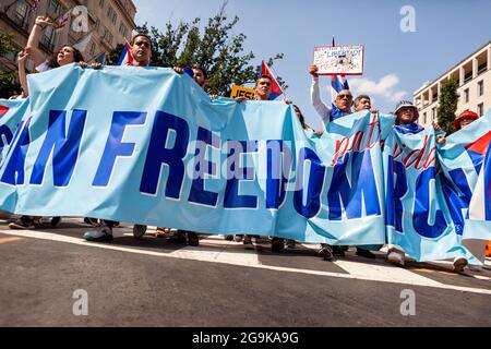 Washington, DC, USA, 26 July 2021.  Pictured: Protesters carry the lead banner of the Cuban Freedom March into Lafayette Square.  Hundreds of Cuban Americans from around the United States came to Washington for the march, demanding that the Biden Administration intervene to remove President Miguel Diaz-Canel and restore freedom to Cuba.  The march took place on Día de la Revolución, the anniversary of the 1959 revolution that brought Fidel Castro to power.  Credit: Allison Bailey / Alamy Live News Stock Photo