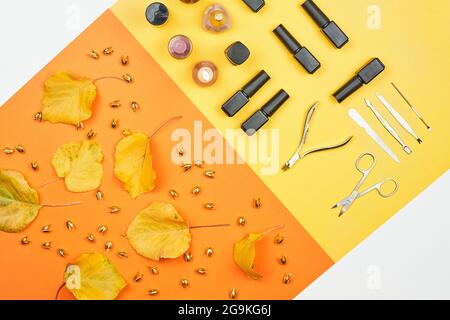 Autumnal manicure background with professional manicure tools and instruments set on the orange background Stock Photo