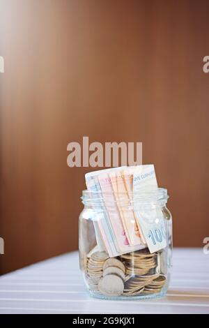 Turkish money liras and coins in jar.Blurred Background.Saving money concept. Stock Photo
