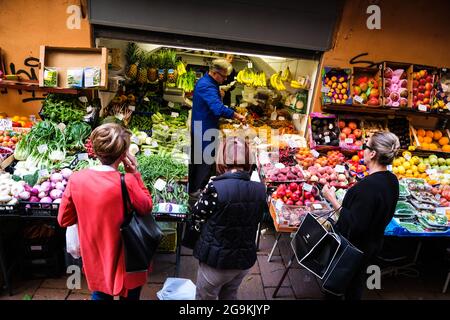 Shoppers buying fruit and vegetables in the Quadrilatero area of Bologna Italy Stock Photo