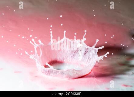 Water drop crown splash on pink yoghurt Stock Photo