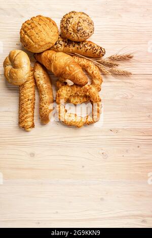 Different bakery products with space for your text on wooden background Stock Photo