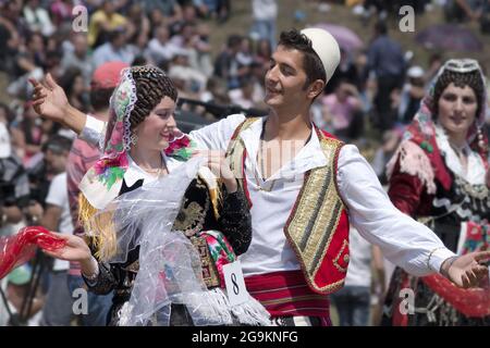 Lepushe, Albania - August 11, 2012: a young couple dressed in traditional Albanian performs in a courtship dance. The beautiful girl is Marsela Bujaj Stock Photo