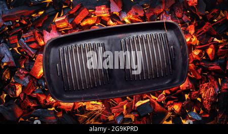 Empty frying pan over hot pieces of coals. Top view. Stock Photo