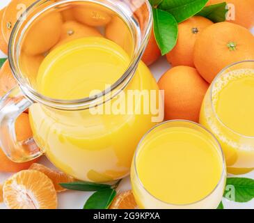 Orange tangerine fruits and fresh tangerine juice close up. Top view. Stock Photo