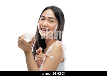 Full body happy young asian woman holding cellphone against