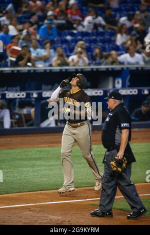 San Diego Padres third basemen Manny Machado (13) hits a home run during an MLB regular season game against the Miami Marlins, Sunday, July 25, 2021, Stock Photo