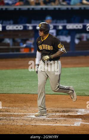 San Diego Padres third basemen Manny Machado (13) hits a home run during an MLB regular season game against the Miami Marlins, Sunday, July 25, 2021, Stock Photo