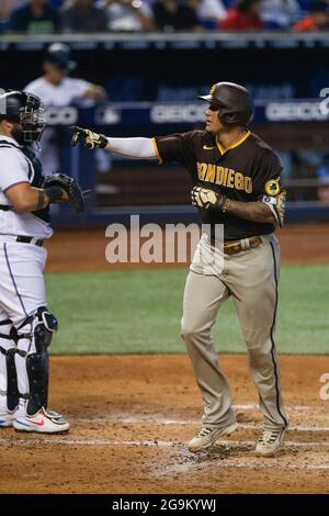 San Diego Padres third basemen Manny Machado (13) hits a home run during an MLB regular season game against the Miami Marlins, Sunday, July 25, 2021, Stock Photo