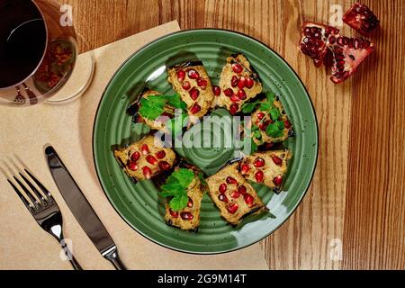 Georgian eggplant rolls stuffed of walnuts with pomegranate and cilantro Stock Photo