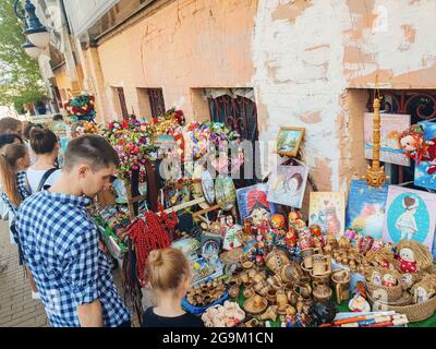 Kiev, Ukraine-April 29, 2018: People looking at souvenirs on counter at Andrew's Descent in Kiev, Ukraine. Stock Photo