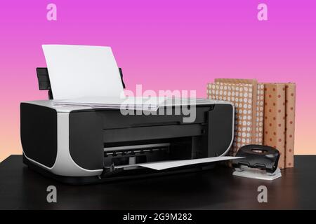 Compact home laser printer against pink background Stock Photo