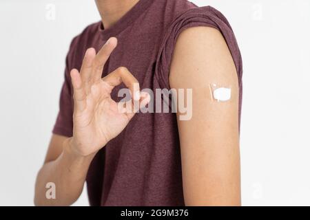 Asian Patient Getting Vaccinated Against Coronavirus by doctor Stock Photo