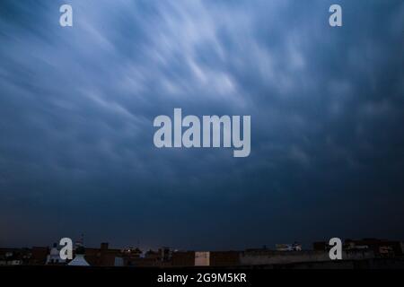 Sunrise dramatic blue sky with orange sun rays breaking through the clouds. Nature background. Hope concept Stock Photo