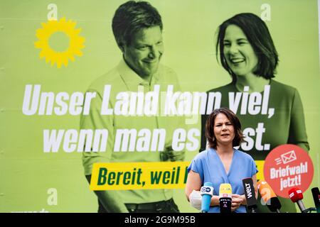 Michendorf, Germany. 26th July, 2021. Annalena Baerbock (Bündnis 90/Die Grünen), party leader and candidate for chancellor, takes part in the unveiling of a large-scale Green poster. This marked the start of the Green Party's nationwide billboard campaign for the federal election. The Green Party Chairwoman is running as a direct candidate in constituency 61 Potsdam - Potsdam-Mittelmark II - Teltow-Fläming II against, among others, the SPD candidate for Chancellor, Scholz. Credit: Fabian Sommer/dpa/Alamy Live News Stock Photo