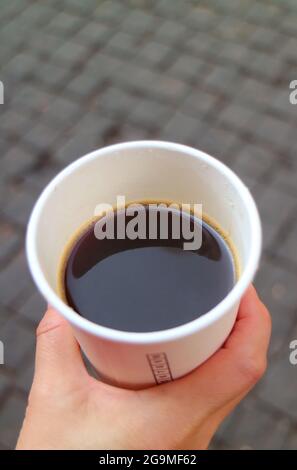 Closeup Hot Coffee in a To-go Paper Cup in Hand Stock Photo