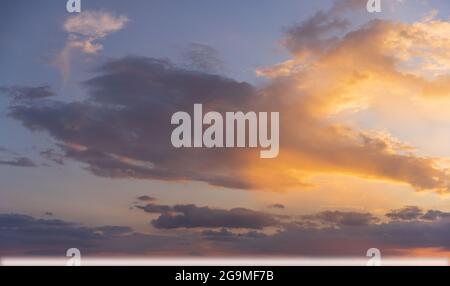 Sky background: sunset reflecting on clouds Stock Photo