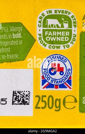 little red tractor logo symbol assured food standards and care in every step from cow to you farmer owned symbol on pack of Anchor butter Stock Photo