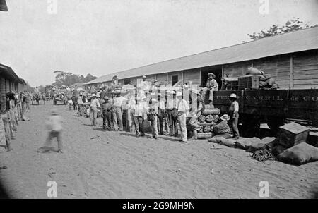 PUNTARENAS, COSTA RICA - circa 1880-1900 - Workers with cargo (probably bananas and coffee among them) at the railroad depot in Puntarenas, Costa Rica Stock Photo