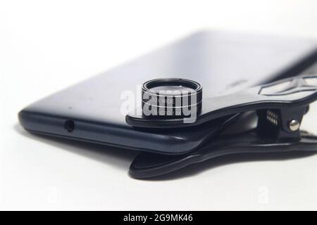 Additional Lens Macro and Wide attached to Smartphone, for super wide photography at white background Stock Photo