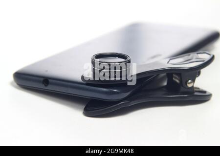 Additional Lens Macro and Wide attached to Smartphone, for super wide photography at white background Stock Photo