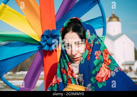 Portrait of unknown beautiful young woman girl in headscarf on her head at Celebration of Maslenitsa Shrovetide holiday in Gomel, Belarus Stock Photo
