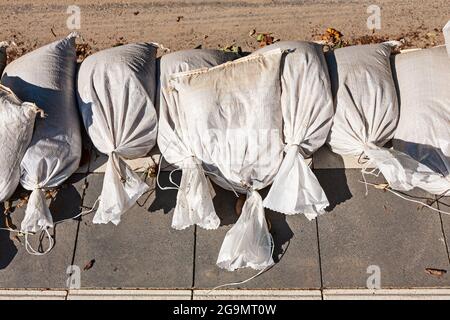 SOLINGEN, GERMANY - JULY 20, 2021: White sandbags for flood defense, Graefrath, Solingen, North Rhine-Westphalia, Germany Stock Photo