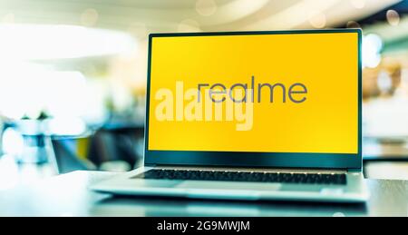 POZNAN, POL - JUL 10, 2021: Laptop computer displaying logo of realme, a Chinese smartphone manufacturer headquartered in Shenzhen Stock Photo