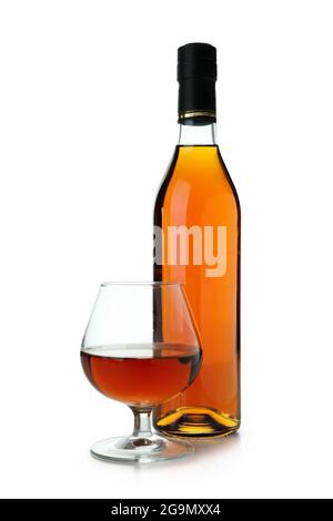 Bottle and glass of cognac isolated on white background Stock Photo