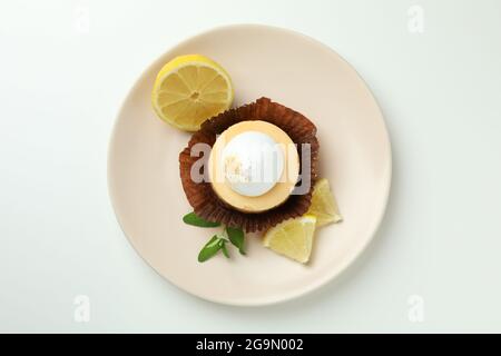Plate with lemon cupcake on white background Stock Photo