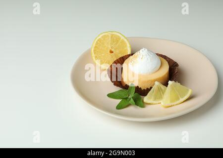 Plate with lemon cupcake on white background Stock Photo
