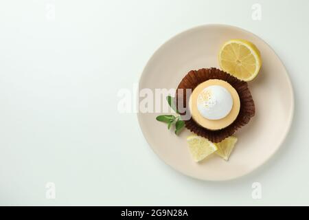 Plate with lemon cupcake on white background Stock Photo