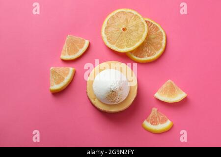 Lemon cupcake and lemon slices on pink background Stock Photo