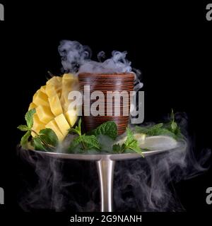 hookah bowl with tobacco on an black background Stock Photo