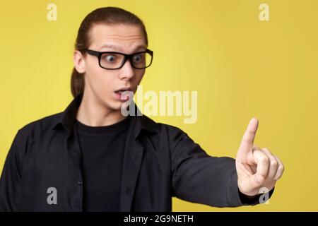 young man in glasses touching virtual screen Stock Photo