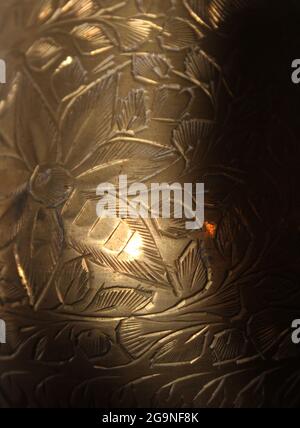 A Detail of a Hand-Etched Brass Vase Stock Photo