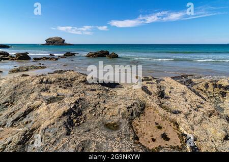 Low Tide – Detail of Colonised Rocks, Pool and Sea View on Portreath Beach with Blue Sky in Early Summer. Stock Photo