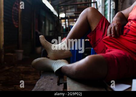 Salvador, Bahia, Brazil - September 15, 2018: São Joaquim Fair. Man resting from hard work on a table. Goods shippers have little rest as there is a l Stock Photo