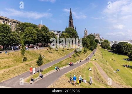 Edinburgh, United Kingdom. 27 July, 2021 Pictured: Despite the predictions of rain and thunderstorms, visitors to Scotland’s capital city, Edinburgh, bask in the sunshine at Princes Street Gardens. Credit: Rich Dyson/Alamy Live News Stock Photo