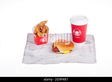 Wendy's bacon, egg, cheese breakfast Sandwich with Seasoned Potatoes & Coffee Cup on wrapper Stock Photo