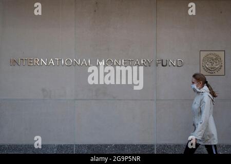 Washington, USA. 30th Mar, 2021. A woman walks past the International Monetary Fund (IMF) headquarters in Washington, DC, the United States, March 30, 2021. TO GO WITH XINHUA HEADLINES OF JULY 27, 2021 Credit: Ting Shen/Xinhua/Alamy Live News Stock Photo