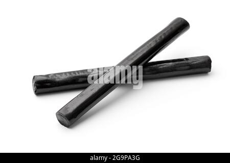 Sticks of black Bay Leaf Licorice isolated on white background Stock Photo