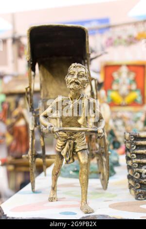 KOLKATA, WEST BENGAL , INDIA - NOVEMBER 23RD 2014 : Miniature rickshaw puller, artwork, handicrafts on display during the Handicraft Fair in Kolkata. Stock Photo