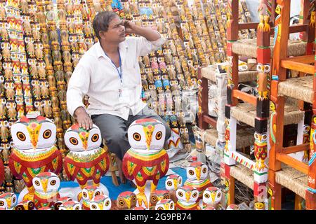 KOLKATA, WEST BENGAL , INDIA - NOVEMBER 23RD 2014 : Unidentified seller selling wooden owls, handicrafts on display at Handicraft Fair in Kolkata. Stock Photo