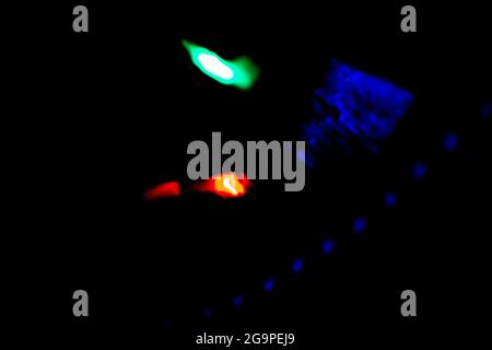 colored bokeh lights sparkling on black background Stock Photo