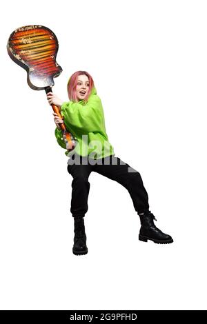 crazy teen girl in green hoodie wants to smash a guitar. isolate on white background Stock Photo