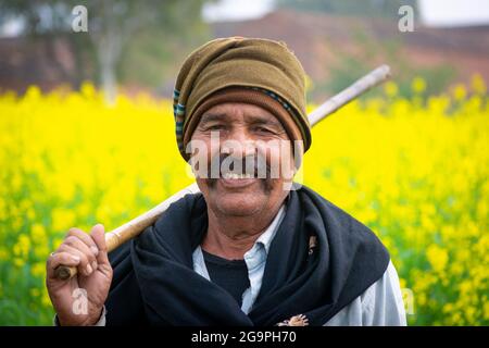 TIKAMGARH, MADHYA PRADESH, INDIA - JULY 16, 2021: Indian farmer standing in agricultural field. Stock Photo