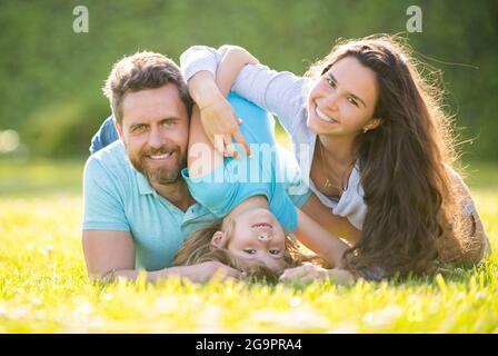 friendly family having fun in summer. happy parents with kid boy. mom dad and son love relax Stock Photo