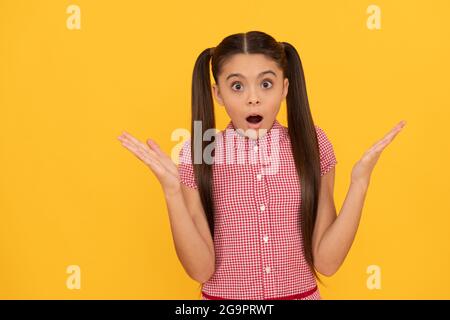 OMG. Surprised child yellow background. Wide-eyed girl got surprised. Surprise and shock Stock Photo